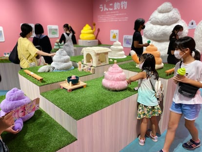 A group of visitors view an exhibit at Tokyo’s poop museum.