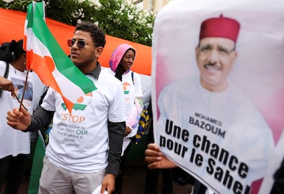 A demonstrator displays an image of the ousted Mohamed Bazoum at a protest against the military coup in Niger, during a demonstration in Paris on August 5.