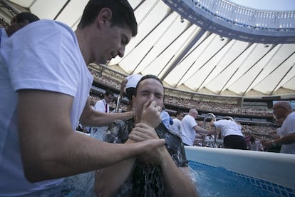 Un creyente es bautizado durante la asamblea de Testigos de Jehová de Madrid. La previsión es que se bautizarán 400 personas. Se calcula que las jornadas tendrán un impacto económico en Madrid de más de 20 millones de euros.