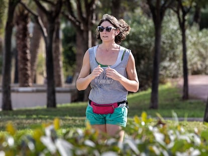 A woman running in a park in Valencia, Spain.