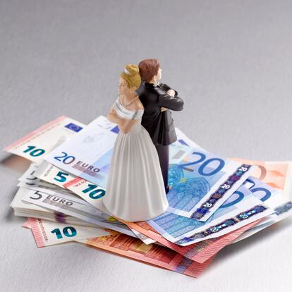 Wedding figurine couple back to back on a pile of Euros