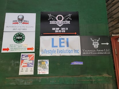 Posters advertising various gun businesses  on a wall in Littleton on October 25.