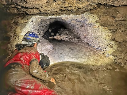 A researcher crawls through a sewage tunnel under the southern end of the Colosseum.