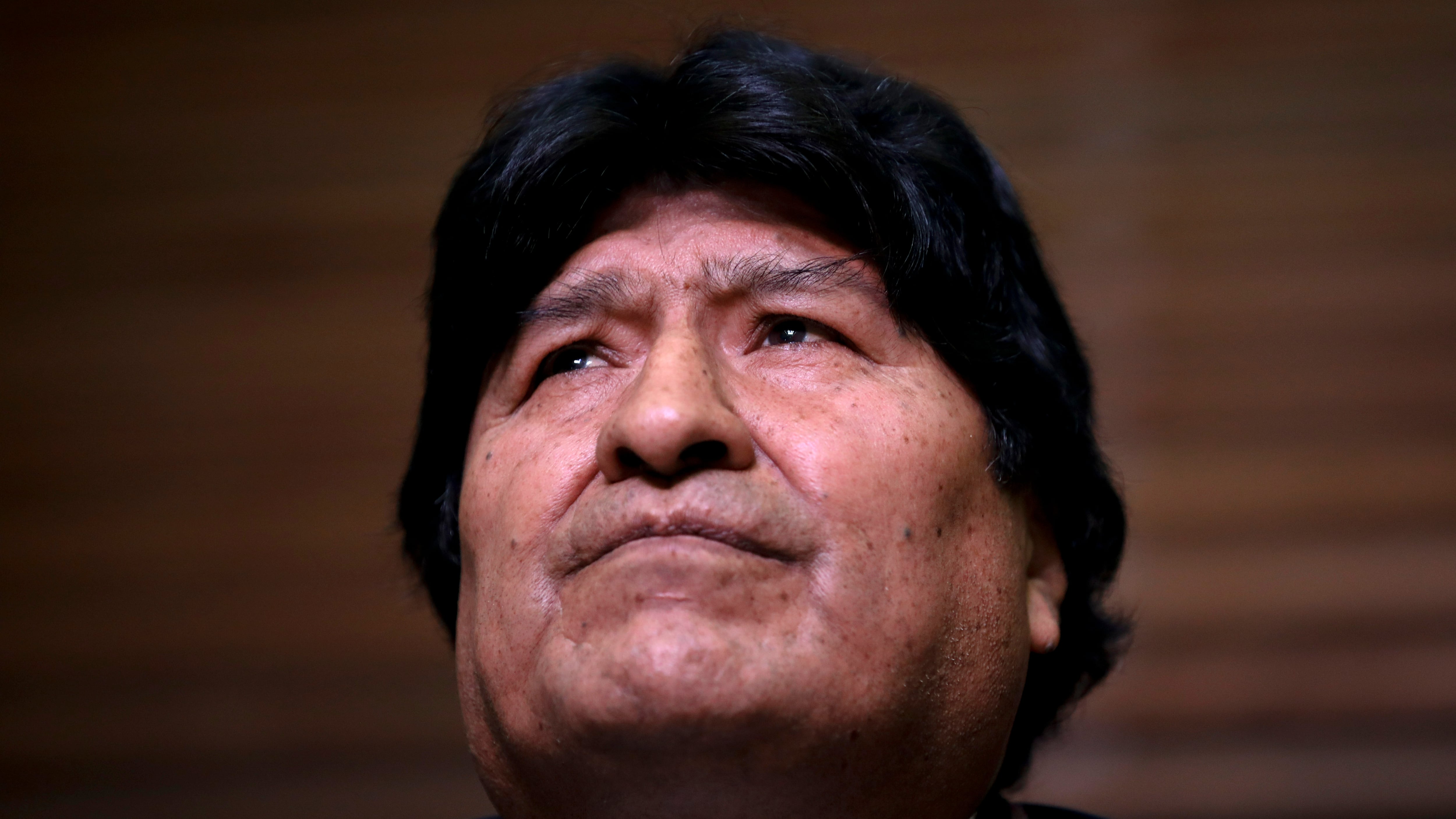 Bolivia's former President Evo Morales looks up as his lawyers speak during a press conference regarding the rejection of his plan to run for Senator in Buenos Aires, where he is living, in Argentina, Friday, Feb. 21, 2020. Bolivia's Supreme Electoral Tribunal on Thursday rejected Morales' candidacy for a Senate seat in May's national elections because he does not reside in the South American country. (AP Photo/Natacha Pisarenko)