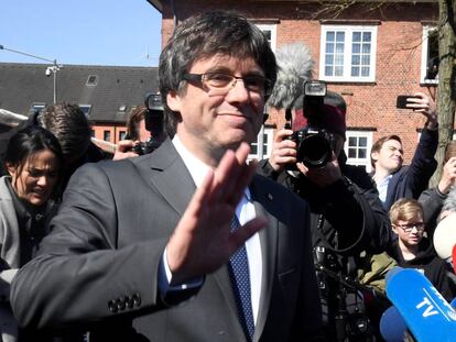 Catalonia’s former premier Carles Puigdemont greets the media as has leaves prison in Neumuenster, Germany on Friday.