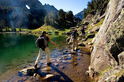 Senderistas en el lago Redon, dentro del parque nacional de Aigüestortes i Estany de Sant Maurici, en el Valle de Arán (Lleida).