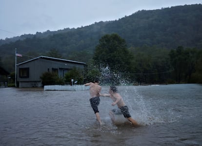 Residents play in floodwaters as Hurricane Helene approaches in the North Carolina mountains, in Valle Crucis, North Carolina, U.S. September 26, 2024. 