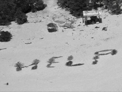 The distress message written by shipwrecked mariners with palm leaves on the beach of an atoll in Micronesia.