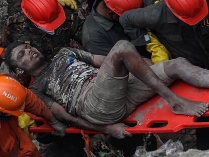 Personal de rescate de la Fuerza Nacional de Manejo de Desastres (NDRF por sus siglas en inglés) rescatan de los escombros, a un superviviente del edificio residencial derribado en la madrugada en el poblado de Bhiwandi, próximo a la capital financiera de Bombay, India, hoy 21 de Septiembre. Al menos diez personas murieron este lunes tras el derrumbe de un edificio residencial en el estado de Maharashtra, en el oeste de la India, mientras que alrededor de una veintena continúa atrapada bajo los escombros.