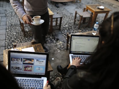 Dos personas con sus portátiles en una cafetería en Estambul (Turquía) en 2014.