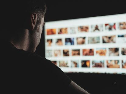 A man looks at online porn in the middle of the night.