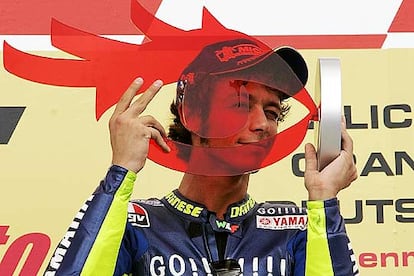 Valentino Rossi juguetea en Alemania con su trofeo transparente.