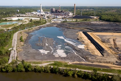 The Richmond city skyline can be seen on the horizon behind the coal ash ponds along the James River near Dominion Energy's Chesterfield Power Station in Chester, Va