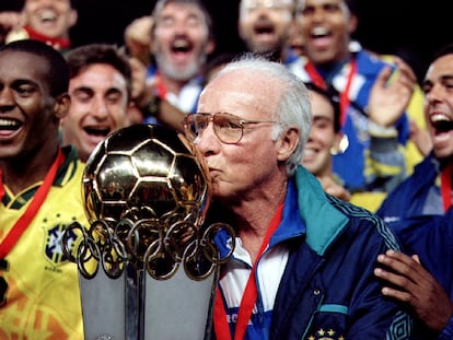 Brazil's coach Mario Zagallo kisses the cup of the South American Olympic soccer championship, surrounded by his team.