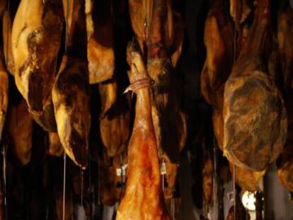 Ham legs being cured at Embutidos Fermín.