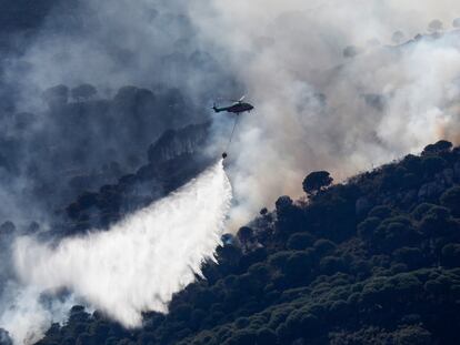 Un helicóptero trabaja en la extinción del incendio de Tarifa, este lunes.