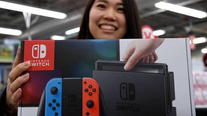 Una joven compra la consola Nintendo Switch en una tienda en Tokio, Japón.