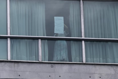 Una mujer pide ayuda desde una ventana del hotel Decápolis este martes, en Ciudad de Panamá.
