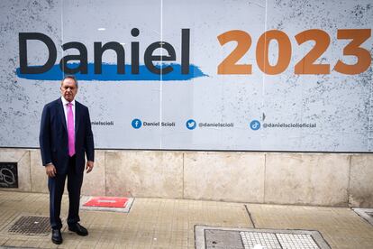 Daniel Scioli junto a uno de sus anuncios de campaña.