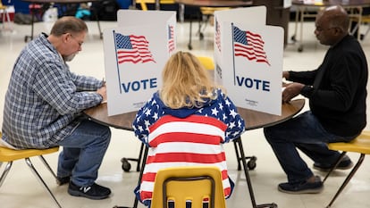 Tres ciudadanos estadounidenses emiten su voto en un colegio electoral en Herndon (Virginia), en marzo de 2020.