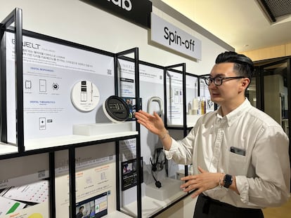 C-Lab employee Jun Kim shows off the smart belt developed by Belt