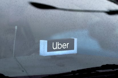 An Uber sign is displayed inside a car, May 15, 2020, in Chicago