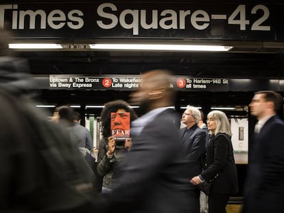 Una mujer muestra el libro 'Fear, Trump in the White House' en el metro de Nueva York.