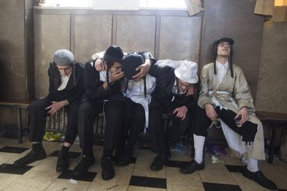 Judíos ultraortodoxos ebrios descansan en un banco, en el barrio Mea Shearim de Jerusalén, el 2 de marzo.