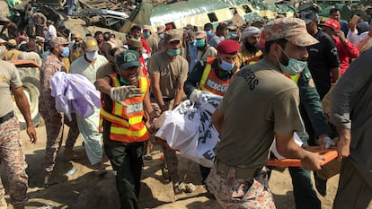 Membros das equipes de resgates sobre o teto de um dos vagões acidentados no choque entre dois trens na província paquistanesa de Sindh, nesta segunda-feira.