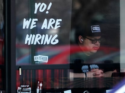A hiring sign is displayed at a restaurant in Schaumburg, Ill., April 1, 2022.
