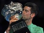 Serbia's Novak Djokovic kisses the Norman Brookes Challenge Cup after defeating Russia's Daniil Medvedev in the men's singles final at the Australian Open tennis championship in Melbourne, Australia, Sunday, Feb. 21, 2021.(AP Photo/Mark Dadswell)