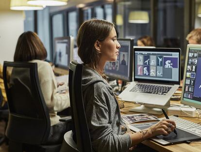 Woman seated at her office in front of her computer, working