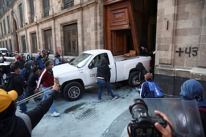 Protesters break down a door of the National Palace, in protest of the Ayotzinapa case, on March 6, 2024.