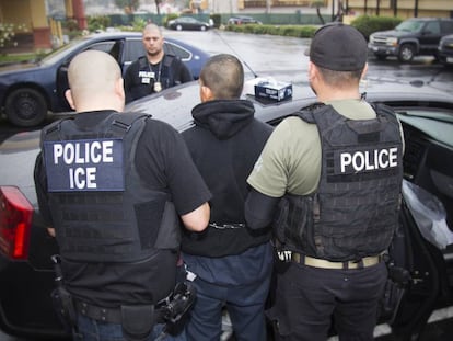 Immigration officers detain a suspected undocumented migrant on February 7 in Los Angeles.