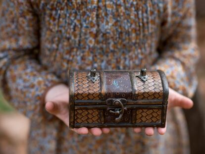 Girl holds a small chest in her hands