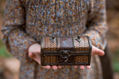 Girl holds a small chest in her hands