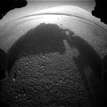 La primera imagen de la cámara frontal del rover, usada para detectar obstáculos durante la travesía. Se puede apreciar a lo lejos el monte central del cráter Gale, Aeolis Mons, objetivo primordial para las investigaciones de Curiosity, y hasta cuyas estribaciones ha llegado el rover 2000 soles después.