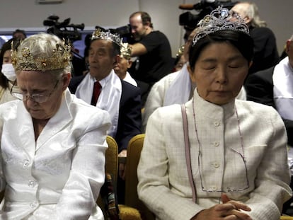 A woman wears a crown and holds an unloaded weapon as she bows her head during services at the World Peace and Unification Sanctuary, Wednesday Feb. 28, 2018, in Newfoundland, Pa. Worshippers clutching AR-15 rifles participated in a commitment ceremony at the Pennsylvania-based church.The event Wednesday morning led a nearby school to cancel classes for the day.The church's leader, the Rev. Sean Moon, said in a prayer that God gave people the right to bear arms. (AP Photo/Jacqueline Larma)