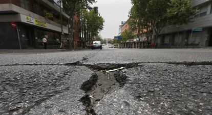 Desperfectos (baches) en el asfalto de la calle Alcalá de Madrid.