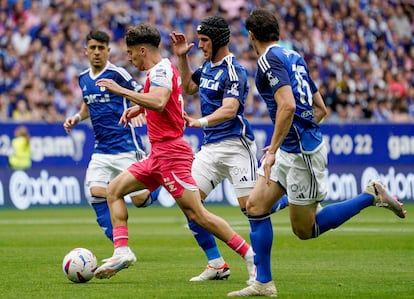 Alvaro Aguado, en posesión del balón, se escapa de tres rivales durante el partido de ida del playoff de ascenso a Primera División.