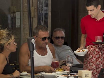 A waiter serves customers in a bar in Ronda, Andalusia.