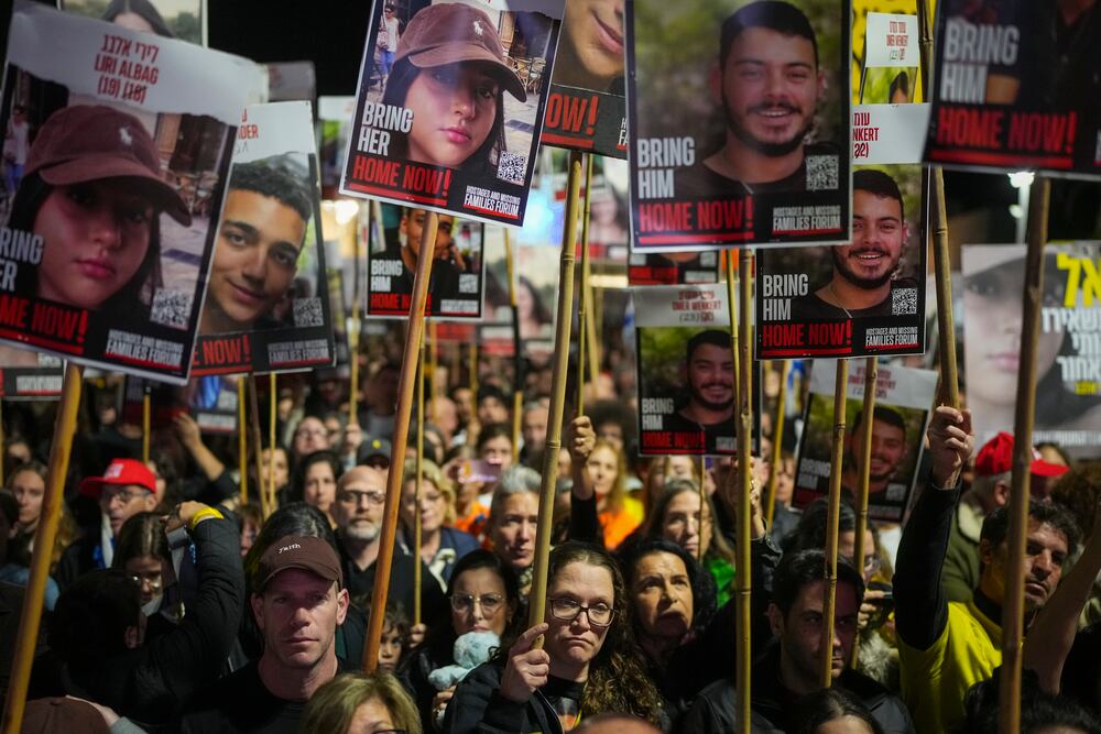 Demonstrators hold portraits of hostages held by Hamas in the Gaza Strip during a protest calling for their immediate release in Tel Aviv, Israel, Saturday Jan. 18, 2025. (AP Photo/Ohad Zwigenberg, File)