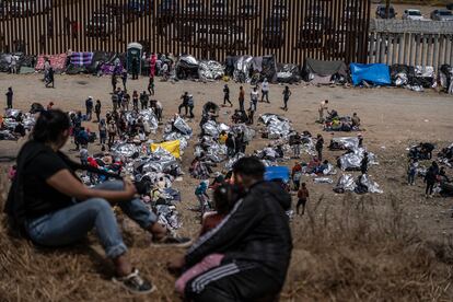 Migrants at a camp set up between the border walls that separate Tijuana and San Diego.
