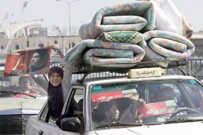 Una niña muestra un cartel del líder de Hezbolá desde uno de los coches de la caravana de regreso al sur de Líbano.
