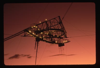 A giant receiver suspended by a cable above the Arecibo radio telescope in a 1992 photograph.