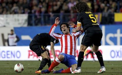 Arda Turan y Puyol en una jornada de la pasada Liga