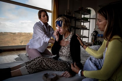 A woman receives help after participating in a psychedelic therapy session with 5-MeO-DMT at a retreat outside Tijuana, Mexico, in 2022.