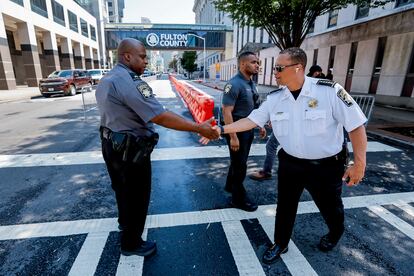 Fulton County Sheriff Patrick Labat (R) greets deputies as enhanced security measures are implemented outside the Fulton County Courthouse and Justice Center ahead of a possible grand jury indictment against former US president Donald J. Trump for 2020 election interference in Atlanta, Georgia, USA, 07 August 2023