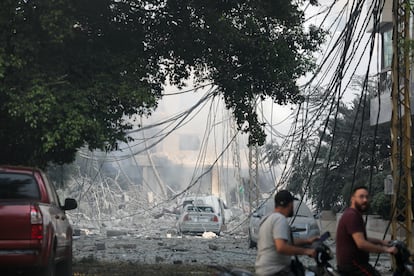 Varios hombres pasan por una zona dañada por los ataques de Israel en Beirut, este sábado. 