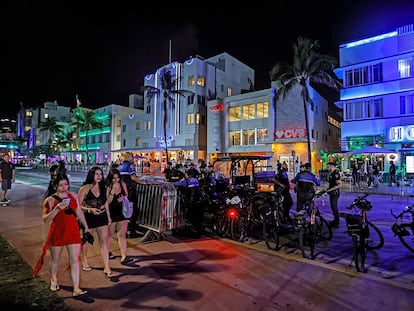 South Beach visitors walk along Ocean Drive during spring break in Miami Beach, Florida, in 2024.